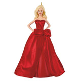 A blonde female doll wearing a strapless red gown with a large bow at the waist, shown against a plain white background.