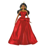 A fashion doll with long black hair, wearing a strapless red gown with a large bow at the waist and gold earrings, shown against a plain white background.