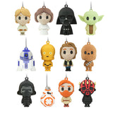 Twelve small character-shaped hanging charms or keychains arranged in a 3-by-4 grid on a plain white background. The characters include recognizable Star Wars figures such as Luke Skywalker, Yoda, Darth Vader, R2-D2, C-3PO, Chewbacca, Black Skull, BB-8, and Darth Maul.