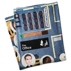 Folded blanket with 'The Office' theme featuring characters and scenes.