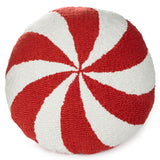 Round tufted pouf pillow with a red and white spiral candy cane pattern, photographed on a solid white background.