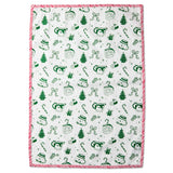 A rectangular white tea towel with a festive Christmas print featuring green illustrations of Santa Claus, Christmas trees, candy canes, and snowman faces, finished with a red and white striped border.