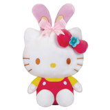 A Hello Kitty plush toy with pink bunny ears, a pink bow, and a blue flower accessory, wearing a red outfit with yellow sleeves, on a plain white background.